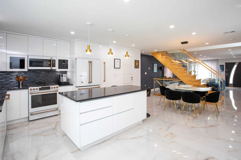Luxury kitchen featuring premium wood cabinets with marble island and designer lighting - Captivating Cabinets