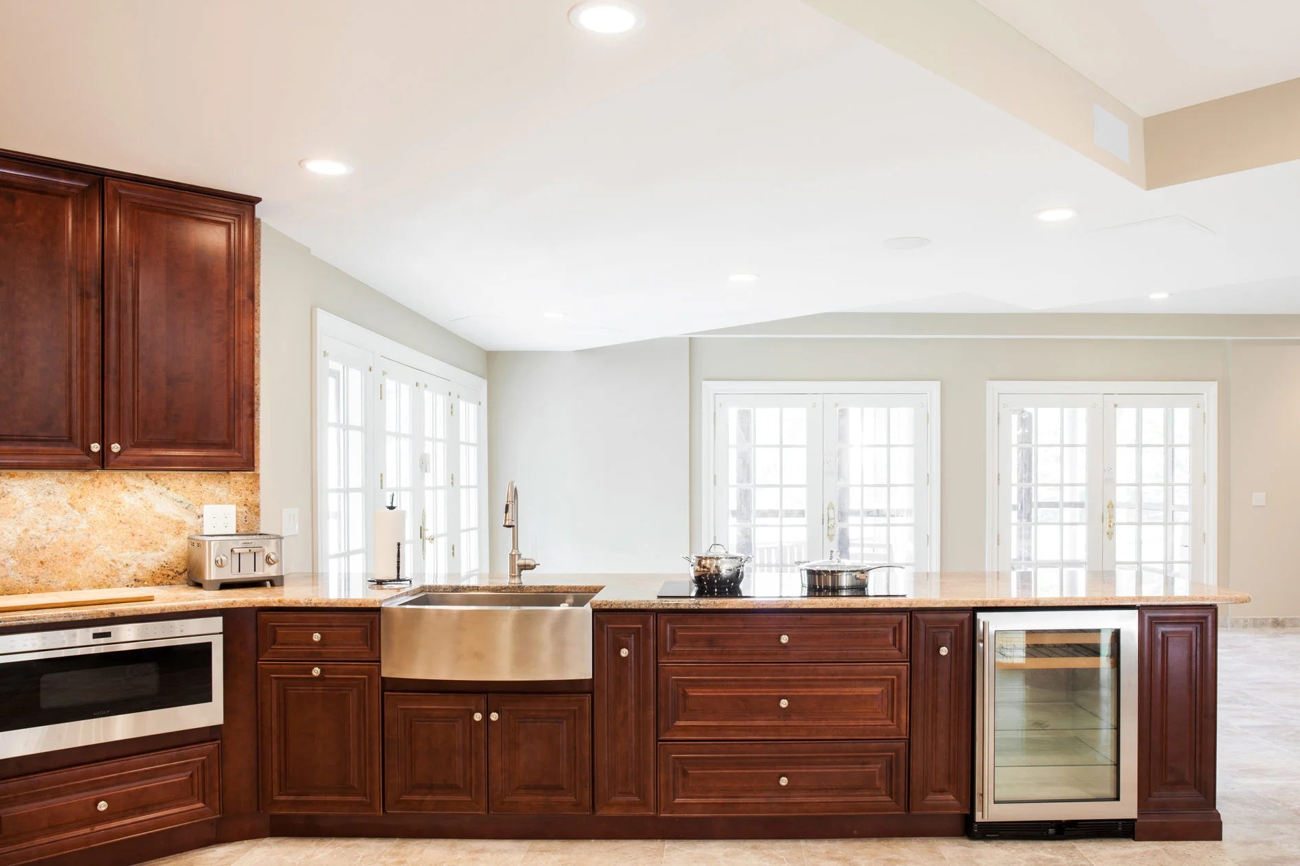 J&K Traditional glazed kitchen cabinets featuring elegant raised panel doors with rich glazed finish, ornate details, delicate curves, and formal traditional styling with solid wood construction
